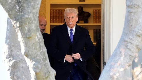 US President Donald Trump walks from the Oval Office to departing on Marine One from the South Lawn of the White House, Friday, Feb. 14, 2025, in Washington.