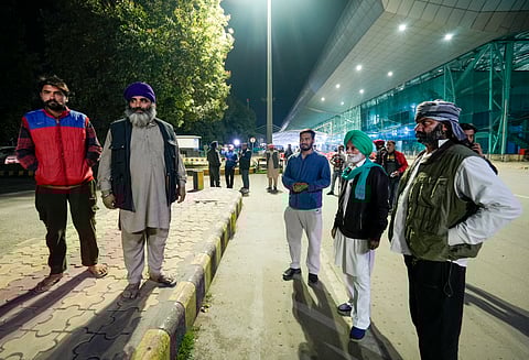 Relatives wait outside the airport ahead of the second batch of the immigrants' arrival from the US, in Amritsar, Saturday, Feb. 15, 2025.