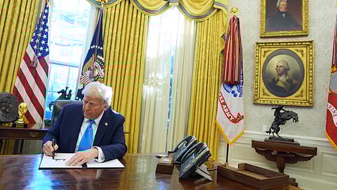 President Donald Trump signs an executive order in the Oval Office of the White House, Tuesday, Feb. 4, 2025, in Washington.