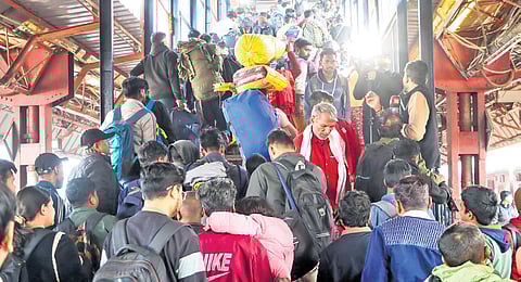 A large crowd on the stairs to a platform at New Delhi railway station.