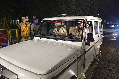 Police personnel take people deported from America for initial checks, in Amritsar, Monday, Feb. 17, 2025. A US military aircraft carrying 112 Indians living illegally in that country landed at the Amritsar airport late on Sunday.