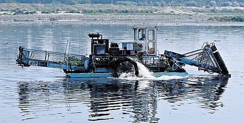 Cleaning work underway at the Yamuna river, in New Delhi on Monday.