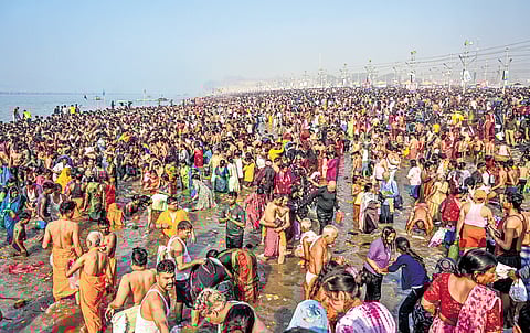 Devotees take a holy dip at the Sangam in Prayagraj on Monday