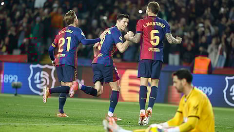 Barcelona's Robert Lewandowski, centre, celebrates after scoring his side's opening goal during a Spanish La Liga soccer match between Barcelona and Rayo Vallecano.