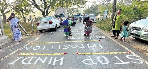 Women drawing rangoli in Maduravoyal on Wednesday