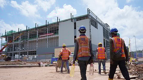 Construction workers walk to a Data centre building under construction in Sedenak Tech Park in Johor state of Malaysia, Friday, Sept. 27, 2024.