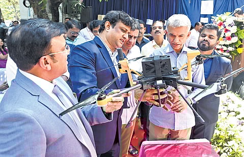 Revenue Minister Krishna Byre Gowda observes the workings of a new tech-based rover that is aimed to expedite and simplify the land survey process, in Bengaluru on Wednesday