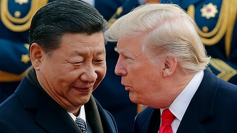 US President Donald Trump, right, chats with Chinese President Xi Jinping during a welcome ceremony at the Great Hall of the People in Beijing on Nov. 9, 2017.