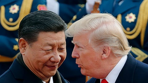 FILE | US President Donald Trump, right, chats with Chinese President Xi Jinping during a welcome ceremony at the Great Hall of the People in Beijing on Nov. 9, 2017.