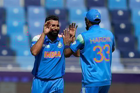 India's Mohammed Shami, left, celebrates with teammate Hardik Pandya after the dismissal of Bangladesh's Mehidy Hasan Miraz (Photo | AP)