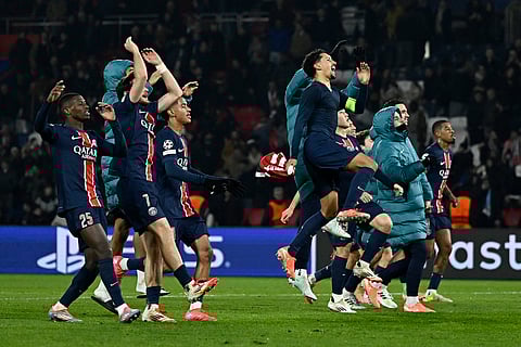 PSG's players celebrate their victory at the end of the UEFA Champions League knockout phase play-off 2nd leg football match between Paris Saint-Germain and Brest at the Parc des Princes stadium in Paris on February 19, 2025.