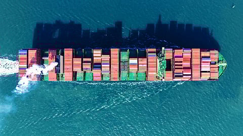 This aerial picture shows a container ship sailing out of Qingdao port, in China’s eastern Shandong province on February 17, 2025.