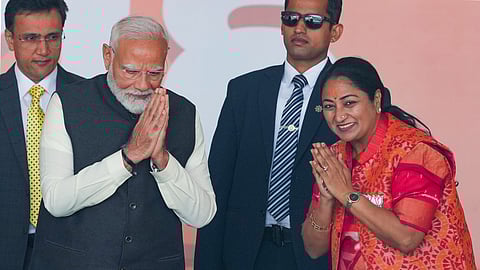 Prime Minister Narendra Modi exchanges greetings with newly sworn-in Delhi Chief Minister Rekha Gupta during the swearing-in ceremony of the Delhi govrnment, in New Delhi, Thursday, Feb. 20, 2025.