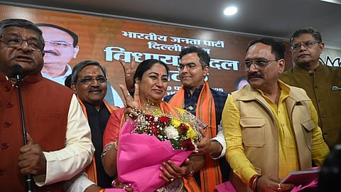 Newly-elected CM Rekha Gupta with other party members at the BJP headquarters in Delhi.
