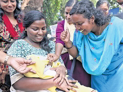 An ASHA worker with the three-month-old daughter of her colleague, Surabhi S S, during the protest in front of the Secretariat on Friday | B P Deepu