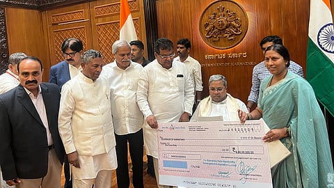 KSHDCL Chairman Roopa Kala Sashidhar handed over a Rs six crore cheque to CM Siddaramaiah, in the presence of ministers K H Muniyappa and M B Patil.