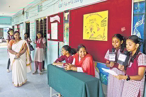 Students of the government school in Ibrahimpatnam present their bulletins during a lunch break in Hyderabad