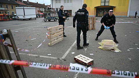 French municipal police officers work to collect evidence at the site of a bladed weapon attack where a man is suspected of killing one person and wounding two municipal police officers in Mulhouse, eastern France on February 22, 2025.