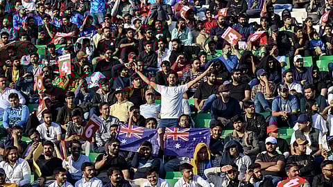 Fans cheer while watching the ICC Champions Trophy one-day international (ODI) cricket match between Australia and England at the Gaddafi Stadium in Lahore on February 22, 2025.
