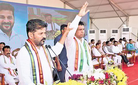 Chief Minister A Revanth Reddy raises the hand of Congress candidate in graduates’ constituency MLC election Narender Reddy during a public
meeting in Karimnagar on Monday
