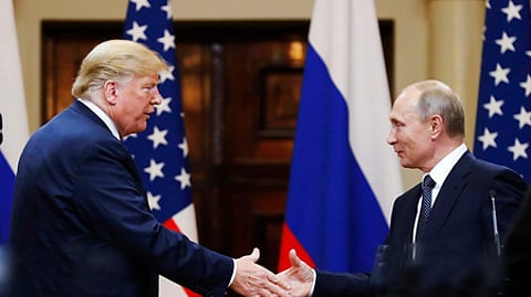 In this file photo taken on Monday, July 16, 2018, U.S. President Donald Trump shakes hands with Russian President Vladimir Puti
