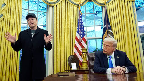 President Donald Trump listens as Elon Musk speaks in the Oval Office at the White House.