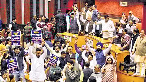 AAP and BJP councillors protest during a meeting of MCD on Tuesday.