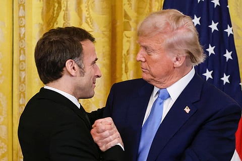 President Donald Trump, right, shakes the hand of France's President Emmanuel Macron during a joint press conference in the East Room of the White House in Washington, Monday, Feb. 24, 2025.