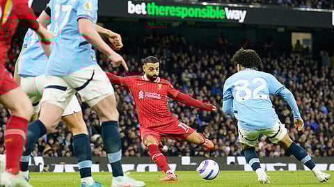 Liverpool's Mohamed Salah, center, scores his side's opening goal during the English Premier League soccer match between Manchester City and Liverpool at Etihad stadium in Manchester, England, Sunday, Feb. 23, 2025.