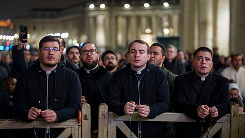 Catholic priests pray the rosary in St. Peter's Square at The Vatican for the recovery of Pope Francis, Monday, Feb. 24, 2025.
