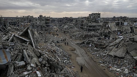 People walk amidst the destruction caused by the Israeli air and ground offensive in Rafah, southern Gaza Strip.