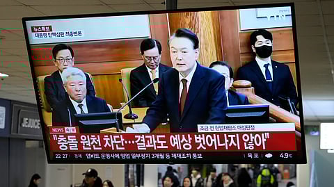 A TV screen shows footage of impeached South Korean President Yoon Suk Yeol's address at the final hearing of his trial during a news program at a bus terminal in Seoul, South Korea, Tuesday, Feb. 25, 2025.