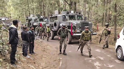 Security personnel during a search operation after an army vehicle came under fire from suspected terrorists.
