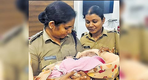 Police with the rescued baby