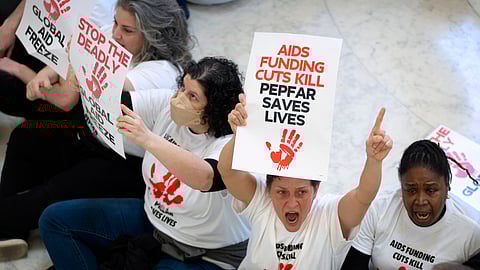 Demonstrators protest against cuts to American foreign aid spending, including USAID and the PEPFAR program to combat HIV/AIDS, at the Cannon House Office Building on Capitol Hill, Wednesday.