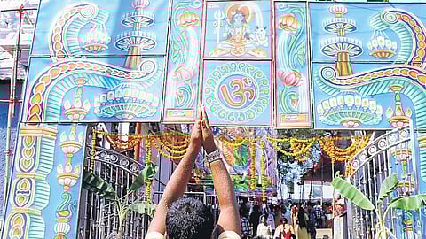 A devotee prays at the premises of Sri Raja Rajeshwara Swamy temple in Vemulawada, Rajanna-Sircilla district on Thursday