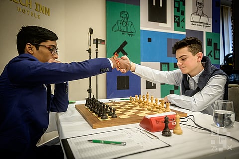 Indian Grandmaster R Praggnanandhaa (L) and Turkey's Gurel Ediz before their game