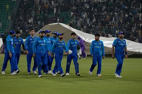 Afghanistan players walk off the field after rain stops play in the ICC Champions Trophy match against Australia in Lahore (Photo | AP)
