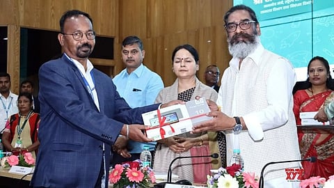 Jharkhand CM Hemant Soren distributes tablets to government school teachers.