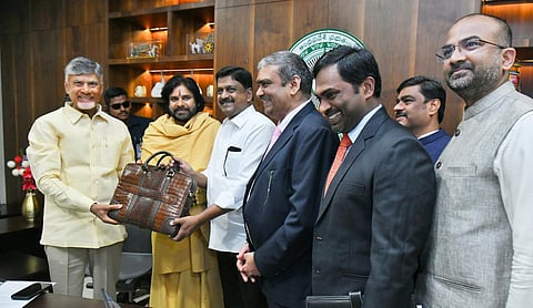 Finance minister Payyavula Kesav handovers budget papers to CM Nara Chandrababu Naidu on Friday.