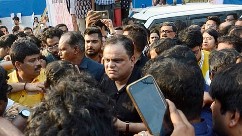 West Bengal Education Minister Bratya Basu, centre, speaks with Students' Federation of India (SFI) members at Jadavpur University campus.