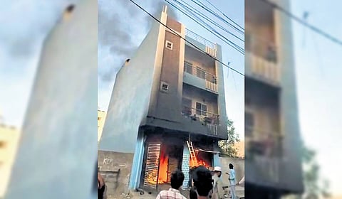A two-storey building on fire at Narsingi in Hyderabad on Friday.