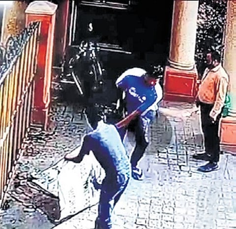 Representatives of the builder removing flex banners at HM Tambourine Apartments on Saturday