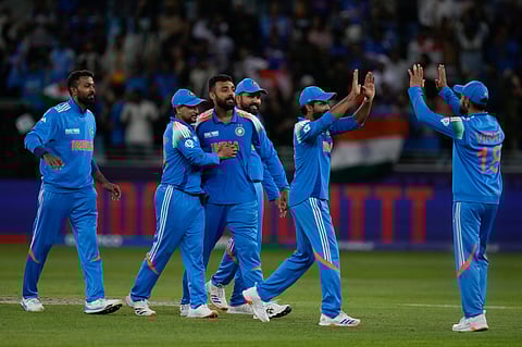 India's Varun Chakravarthy, third from right, celebrate the wicket of New Zealand's Matt Henry with his team mates during the ICC Champions Trophy cricket match between India and New Zealand at Dubai International Cricket Stadium in Dubai, United Arab Emirates, Sunday, March 2, 2025.