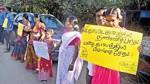 A human chain formed by residents of Thiruneermalai to draw attention of the state government to take measures to desilt Periya Eri in the area.