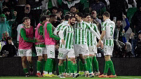 Real Betis' Isco celebrates scoring his team's second goal with teammate Johnny Cardoso, during the Spanish league footbal match between Real Betis and Real Madrid CF at Benito Villamarin Stadium in Seville on March 1, 2025.