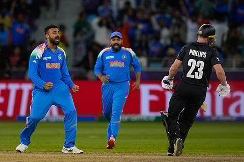 Varun Chakravarthy celebrates a wicket in Dubai