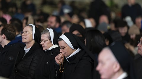 Catholic faithful attend a nightly rosary prayer for the health of Pope Francis in St.Peter's Square at the Vatican, Sunday, March 2, 2025.