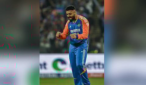 India's Varun Chakravarthy celebrates a wicket in Dubai on Sunday