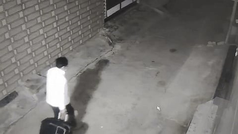 The accused seen carrying the woman's body in a suitcase.